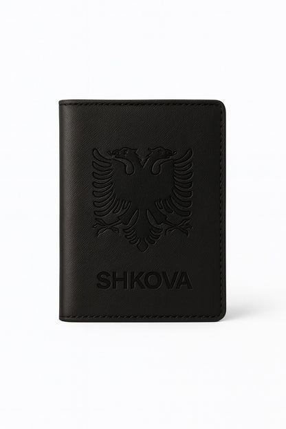 Black leather wallet with embossed design and 'SHKOVA' branding on a white background