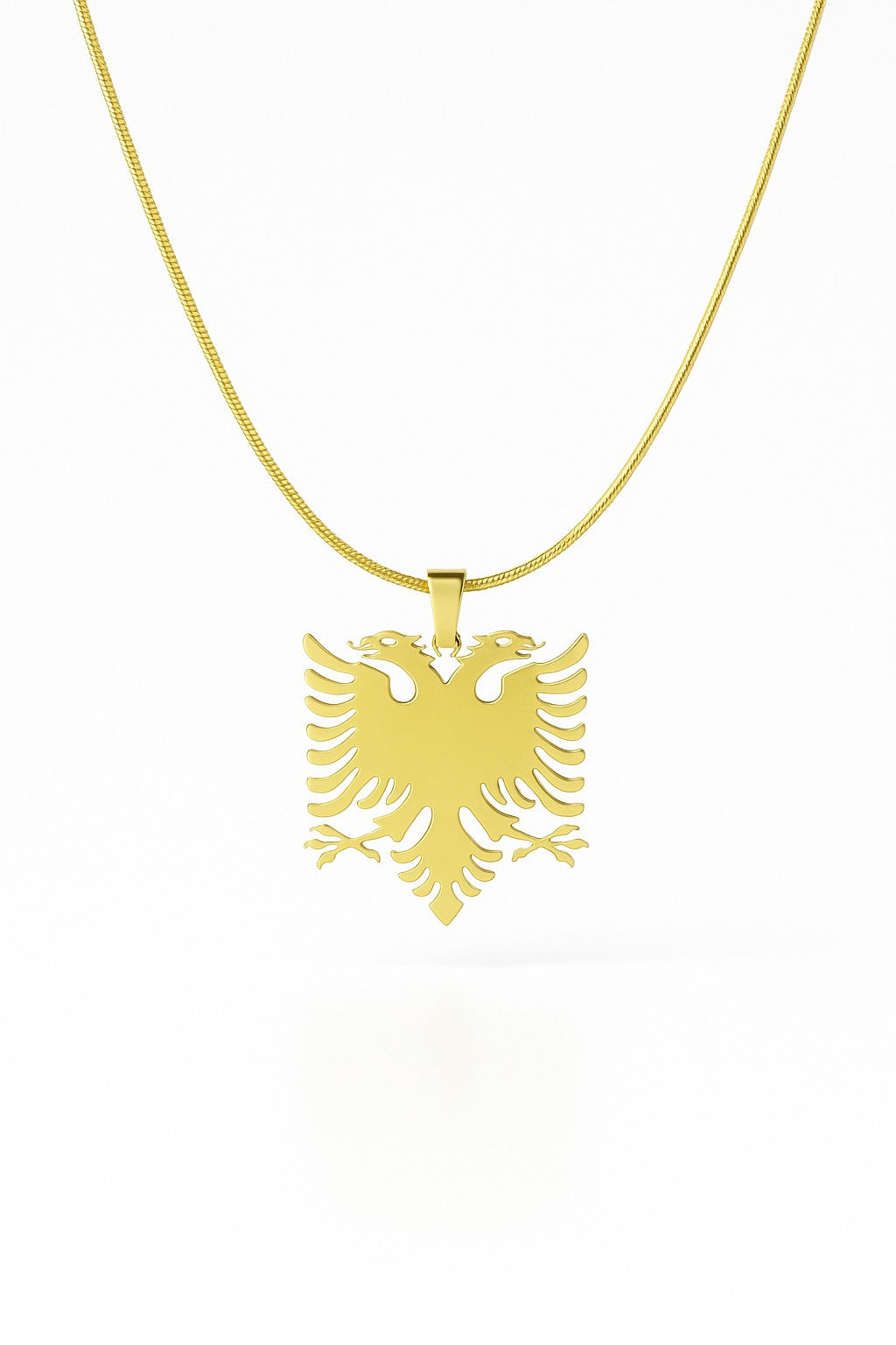 Gold necklace with an eagle pendant on a white background