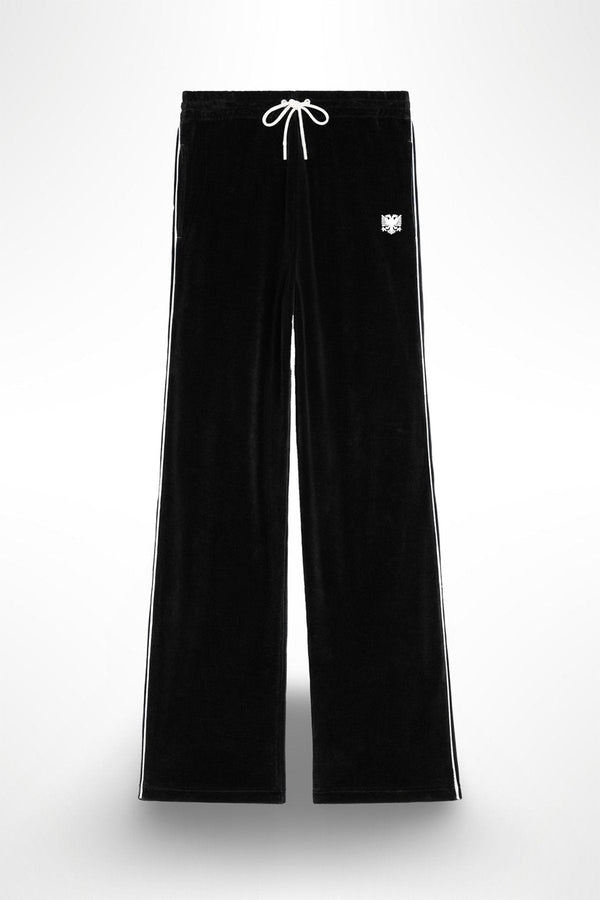 A pair of black velour pants with white stitching and an eagle applique on the left leg, featuring a drawstring waistband.