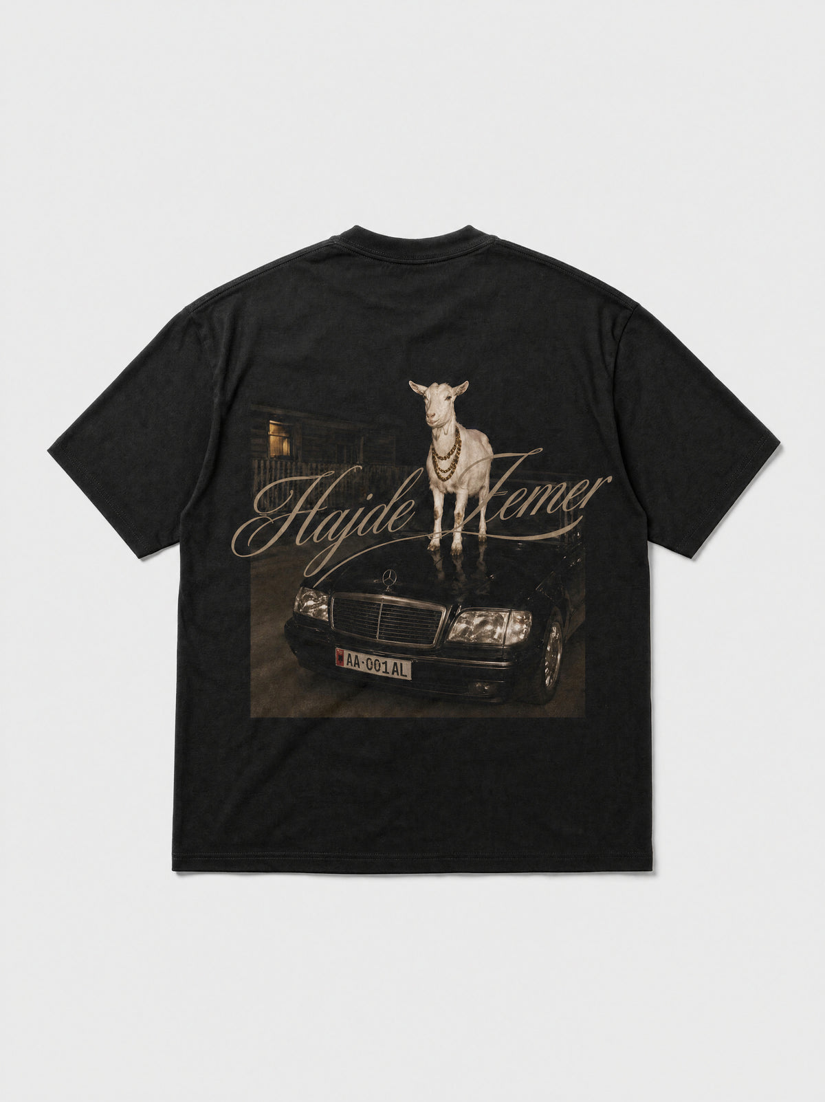 Hajde Zemer black tee laid flat, back view, printed graphic of a goat driving a Mercedes