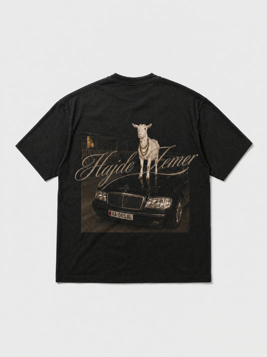 Hajde Zemer black tee laid flat, back view, printed graphic of a goat driving a Mercedes
