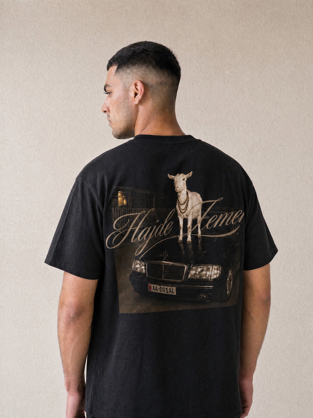 Man wearing the Hajde Zemer black goat tee, back view showing the print