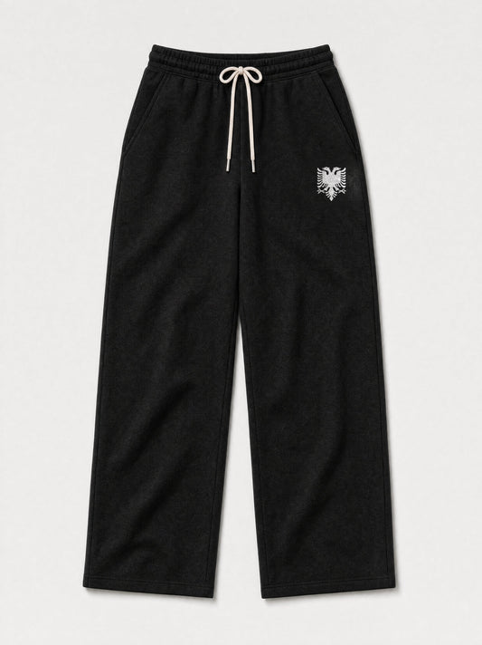 Design preview: Hajde Zemer HZ Essential Eagle Sweatpants in black, front flat lay with the cream double-headed eagle at one hip