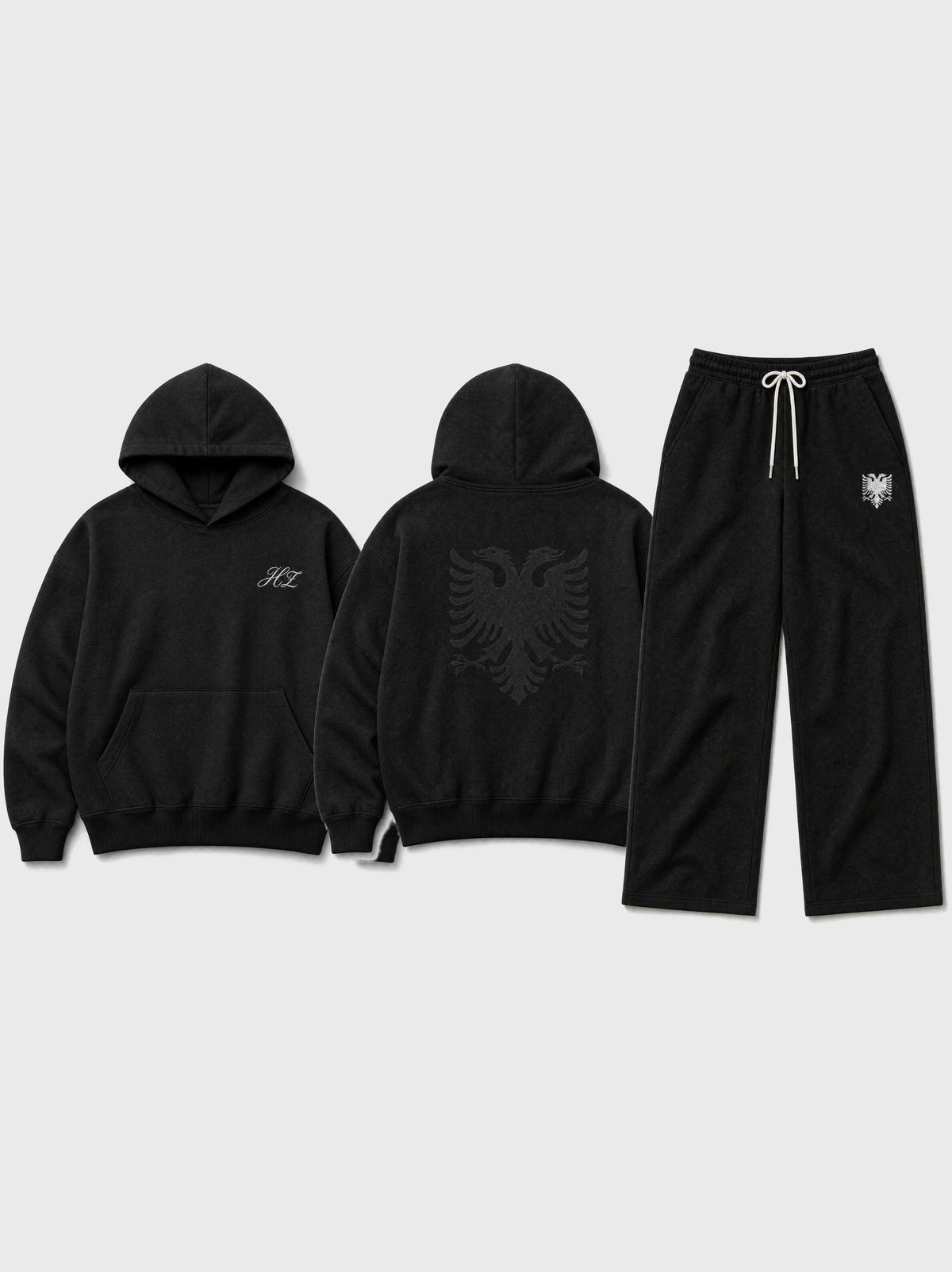Design preview: Hajde Zemer HZ Essential Eagle Set in black, flat lay - hoodie front with the HZ script, hoodie back with the double-headed eagle, and the matching sweatpants with the cream eagle at the hip