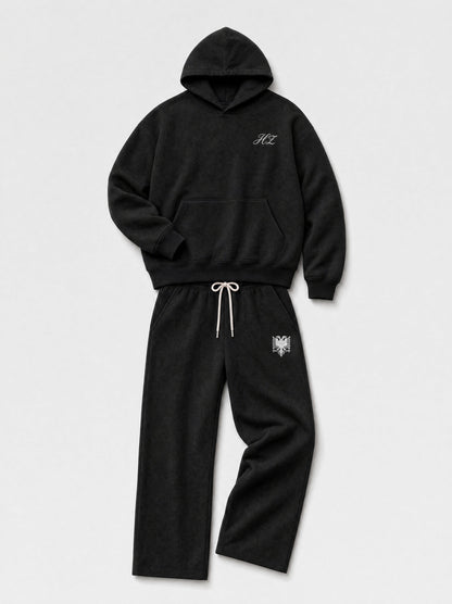 Design preview: Hajde Zemer HZ Essential Eagle Set in black, folded flat lay with the cream eagle at the sweatpant hip