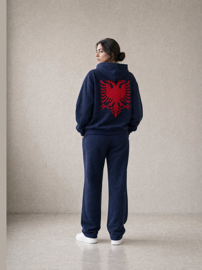 Design preview: Hajde Zemer HZ Essential Eagle Set in blue navy, back view on a female model, red Albanian eagle across the hoodie