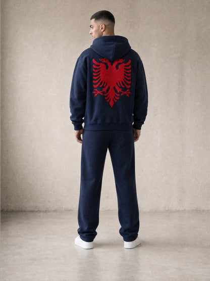Design preview: Hajde Zemer HZ Essential Eagle Set in blue navy, back view on a male model, red Albanian eagle across the hoodie