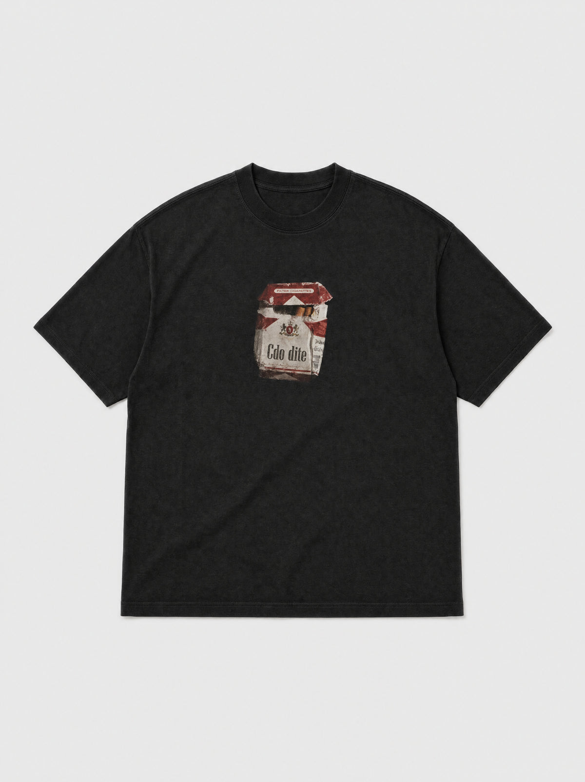 Hajde Zemer black tee laid flat, front view, small printed cigarette packet graphic on the chest