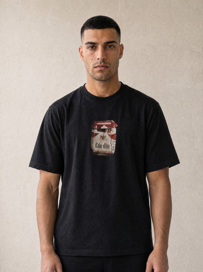 Man wearing the Hajde Zemer black cigarette box tee, front view