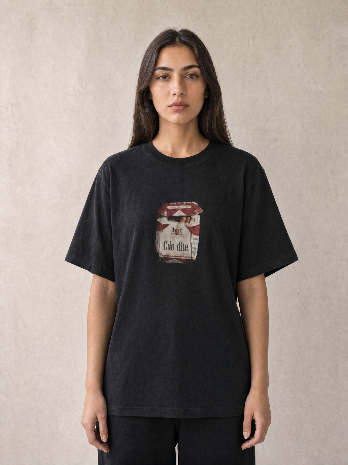Woman wearing the Hajde Zemer black cigarette box tee, front view