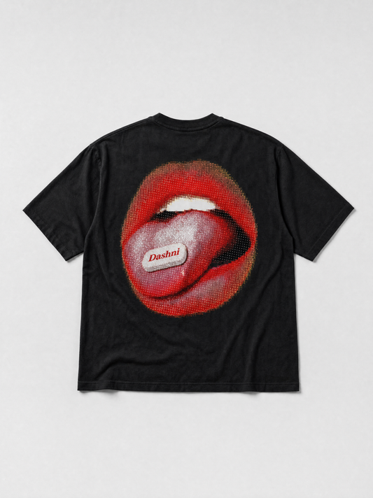 Hajde Zemer Dashni tee in black, laid flat, back view, halftone print of red lips with the tongue out and a Dashni label across the tongue
