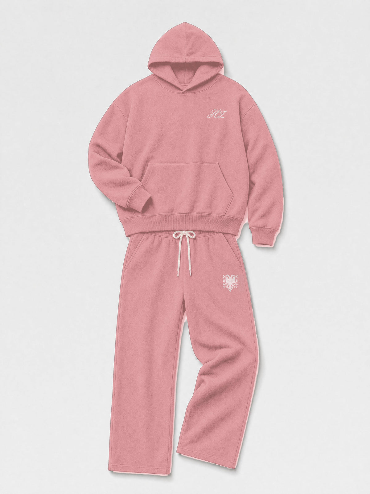 Design preview: Hajde Zemer HZ Essential Eagle Set in dusty rose pink, folded flat lay with the cream eagle at the sweatpant hip