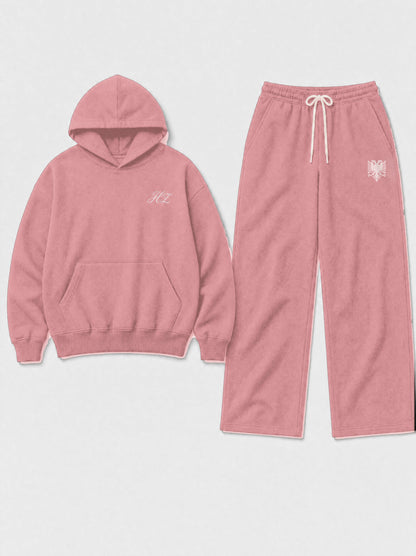 Design preview: Hajde Zemer HZ Essential Eagle Set in dusty rose pink, hoodie and sweatpants laid side by side, cream eagle at the pant hip