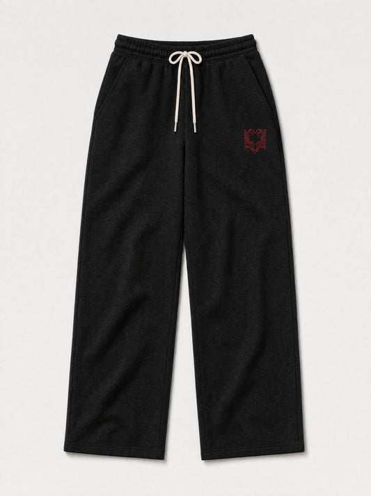 Design preview: HZ Essential Eagle Rhinestone Sweatpants in black, front flat lay, with the Albanian double-headed eagle in red rhinestones on the thigh, below the pocket