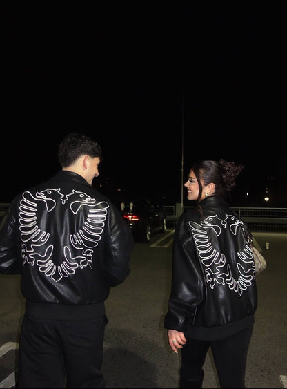 Couple wearing matching Albanian Eagle Jackets — night out