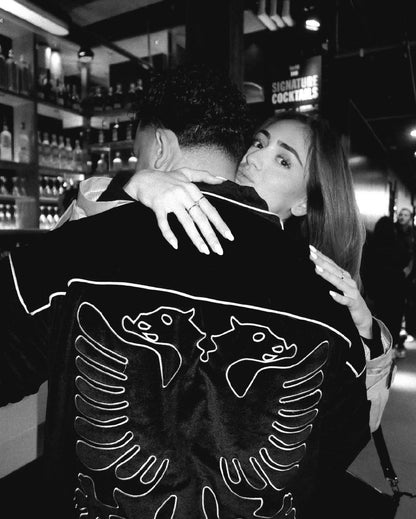 Customer wearing Albanian Velour Jacket White Stitch at cocktail bar